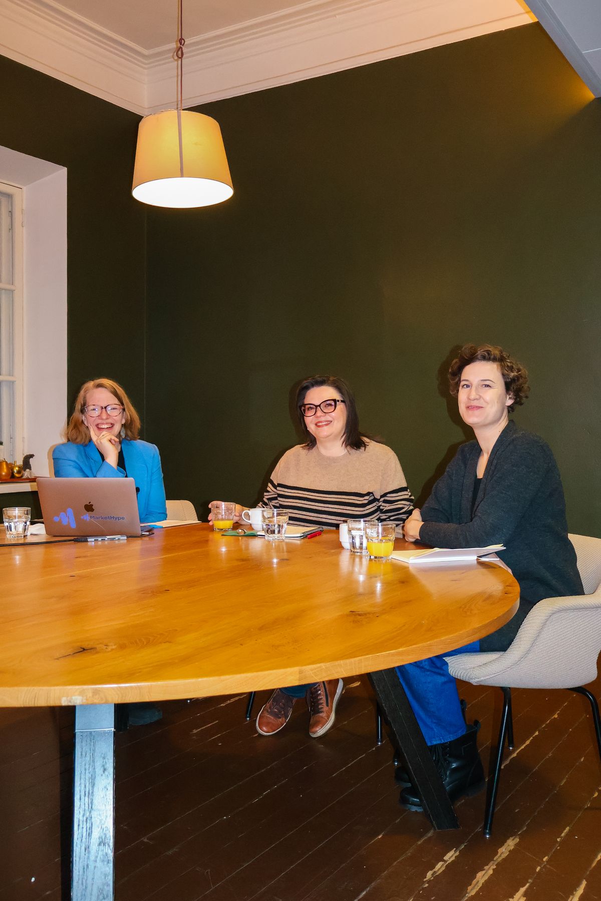 webinar three women at a table and one laptop