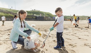 Children picking up litter on a beach
