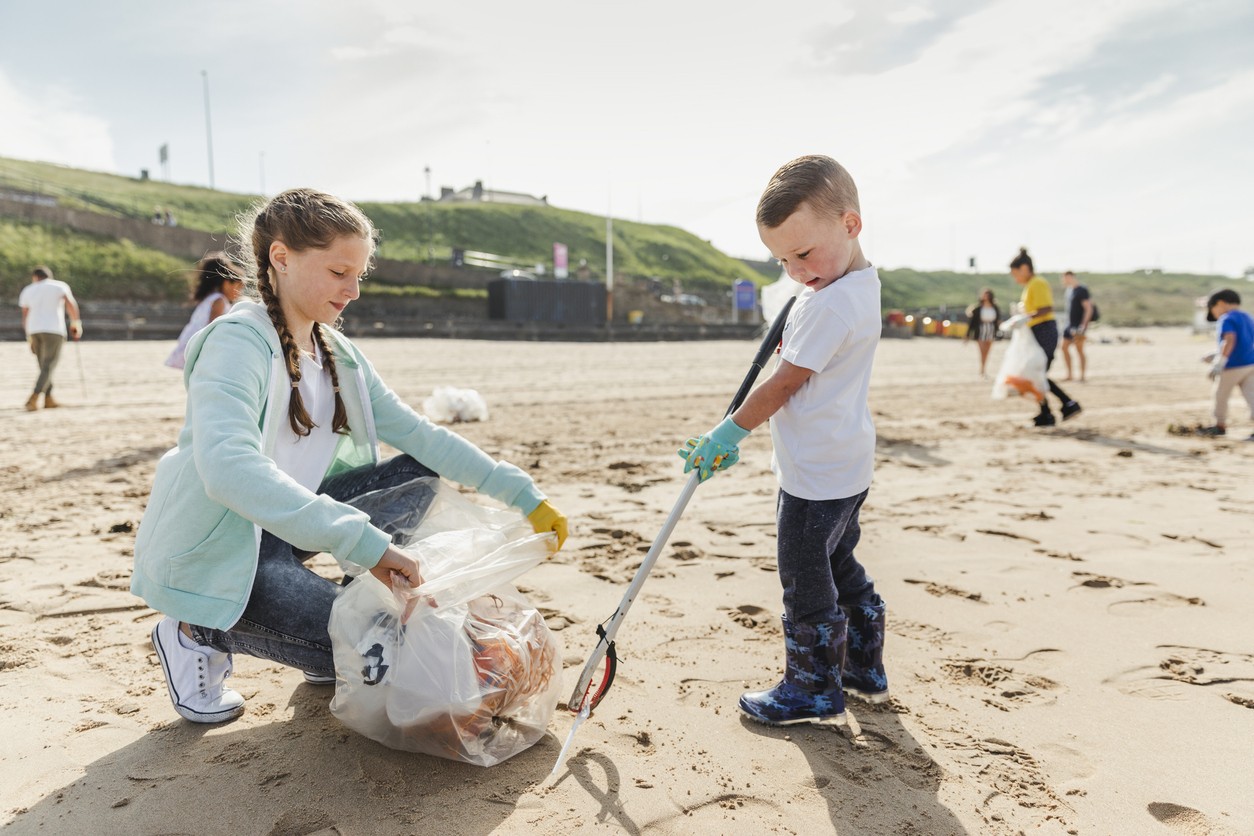 Children picking up litter on a beach