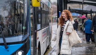 A woman waiting to get on a bus