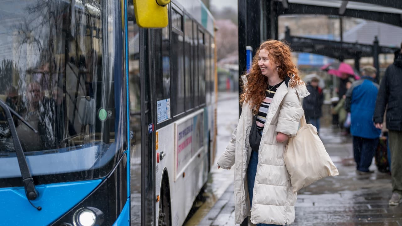 A woman waiting to get on a bus