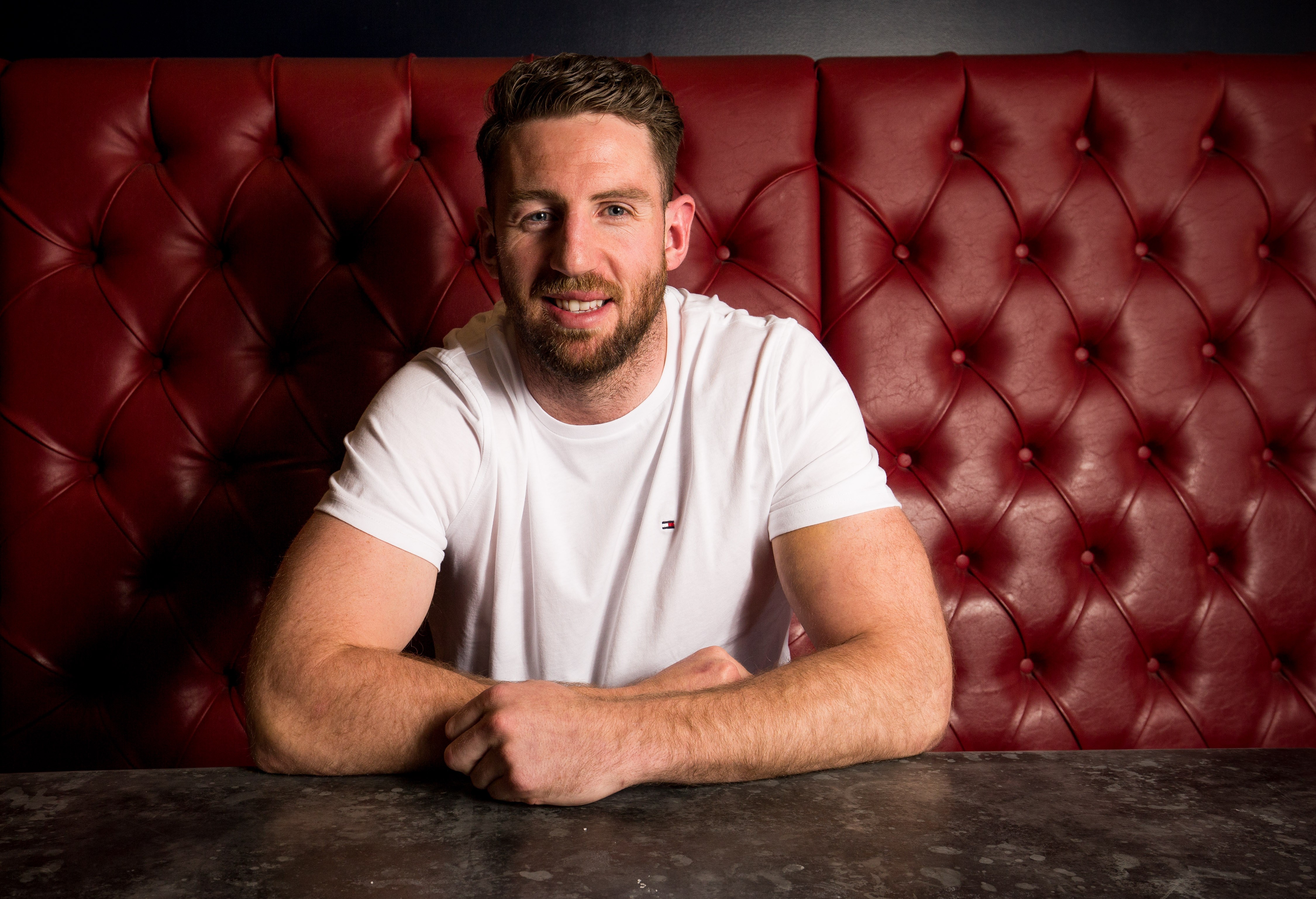 A man sitting at a table, smiling