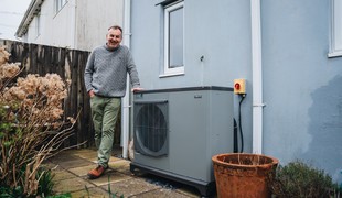 a man standing outside with his heat pump