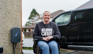 Lauren Francis next to the EV charging port outside her home