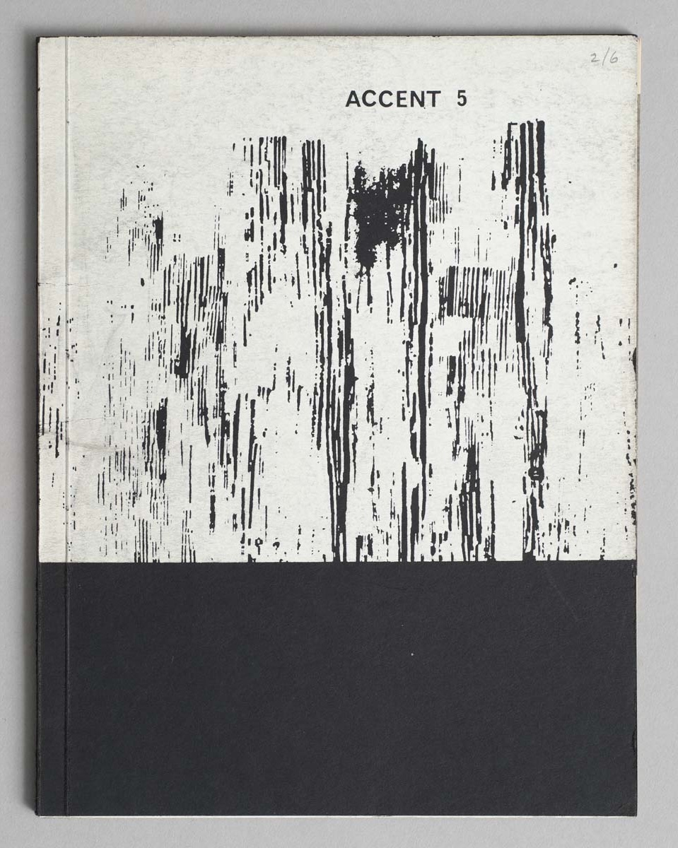 A photograph of a minimalist book cover titled "ACCENT 5" with abstract black vertical streaks on a textured white background, and a solid black bottom section.