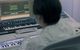 A person sitting in front of a computer.