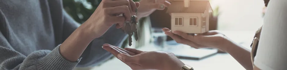estate-agent-giving-house-keys-woman-sign-agreement-office