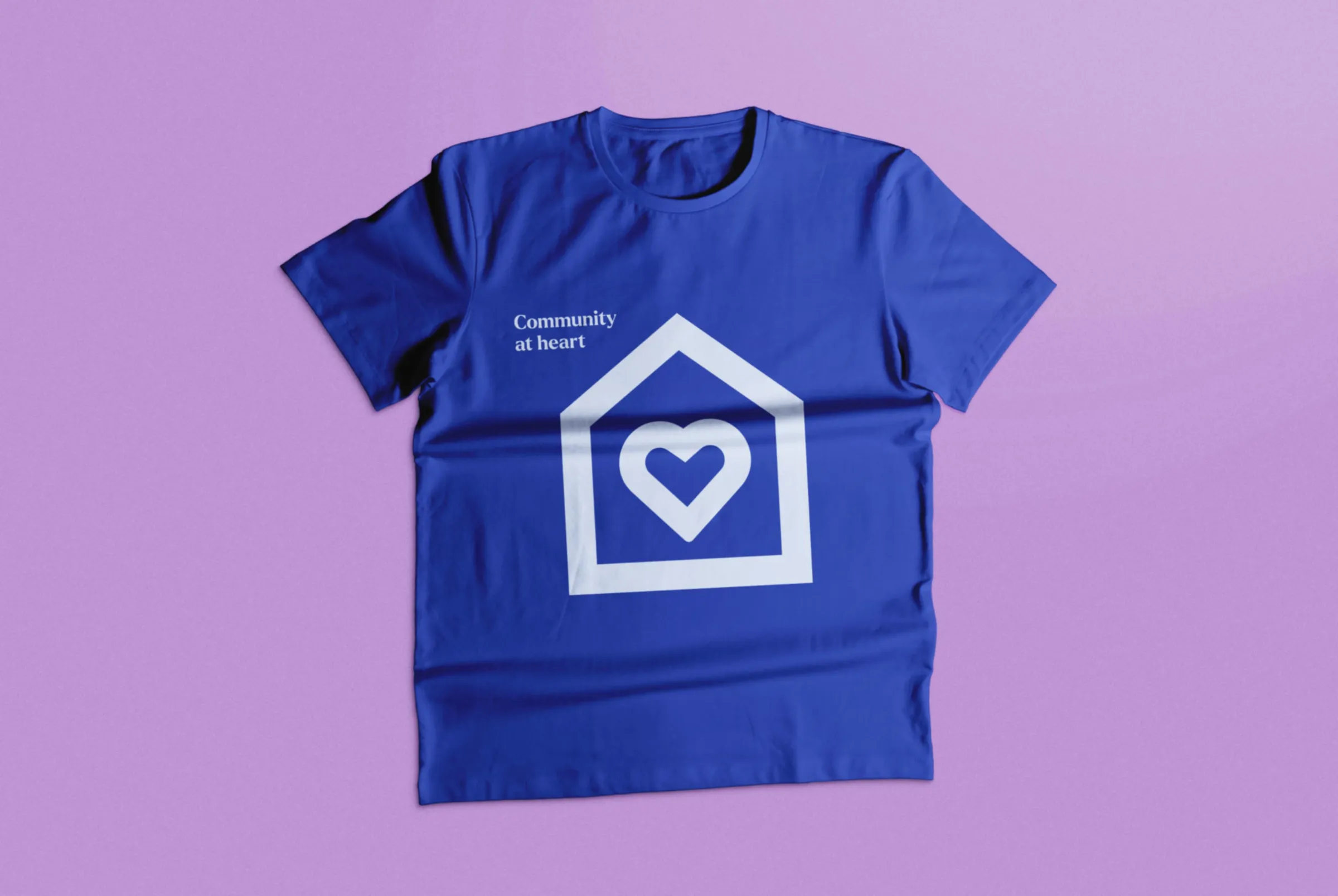A branded t-shirt saying Community at Heart and incorporating a heart symbol into the logo
