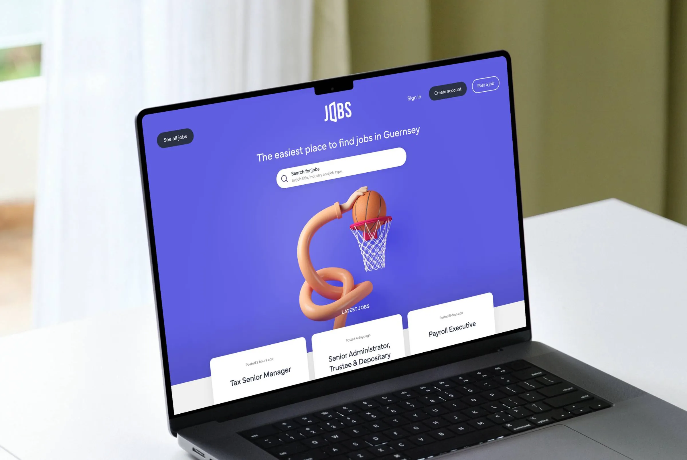 A laptop showing the homepage of the Jobs.gg website