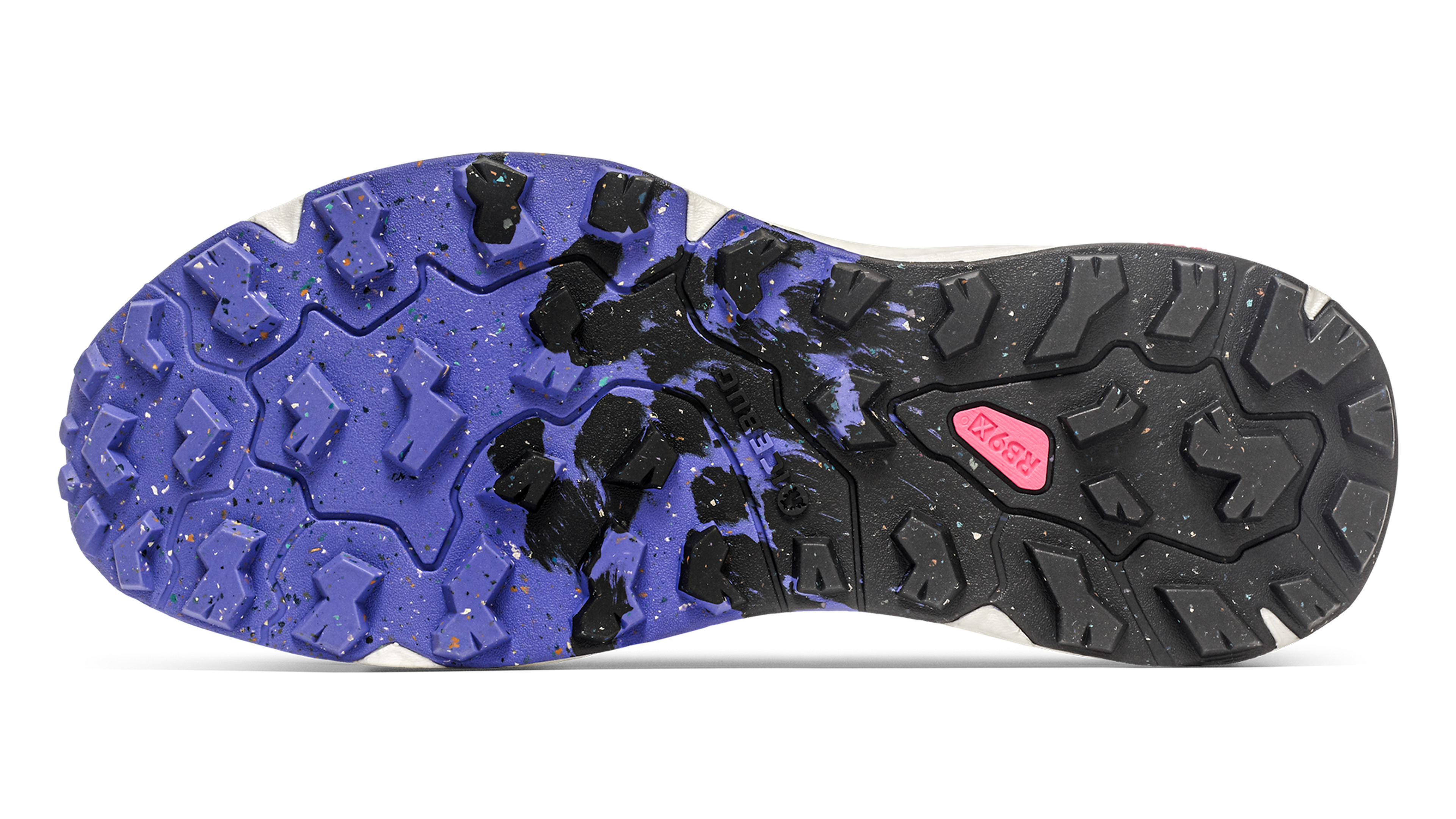 Close-up of a shoe sole with a rugged, multicolored tread pattern in blue, black, and pink, designed for traction.