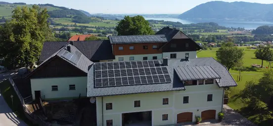 Agricultural building complex with residential wing, heated outbuildings, and five holiday apartments; rooftop PV panels installed.
