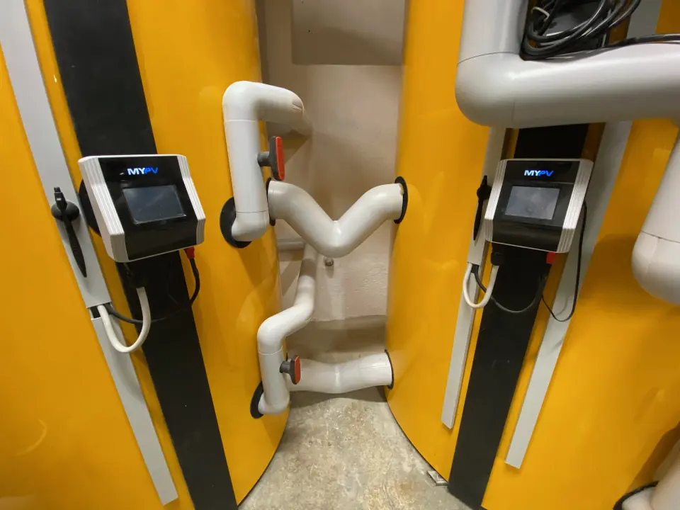 Two yellow water heaters, each equipped with an integrated AC ELWA 2 for solar-electric water heating.