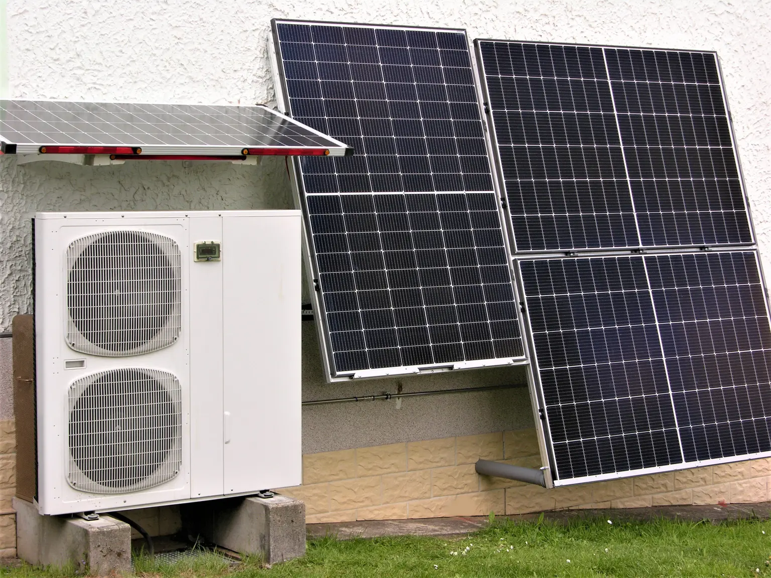 House with white facade and PV panels on the facade
