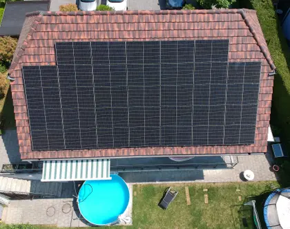 House with 14 kWp PV panels on the roof, a round pool and a trampoline in the garden.