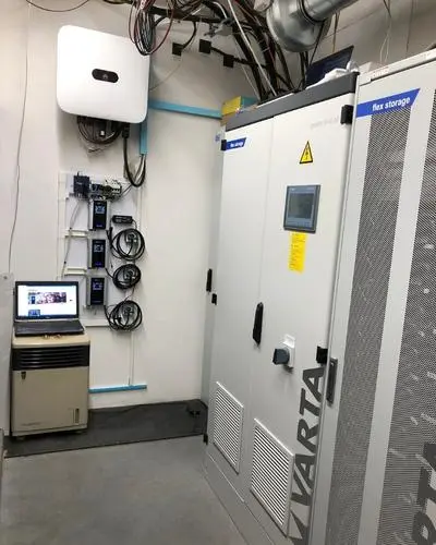 Boiler room with 3 connected AC•THOR units and inverter, a laptop with manual on the side