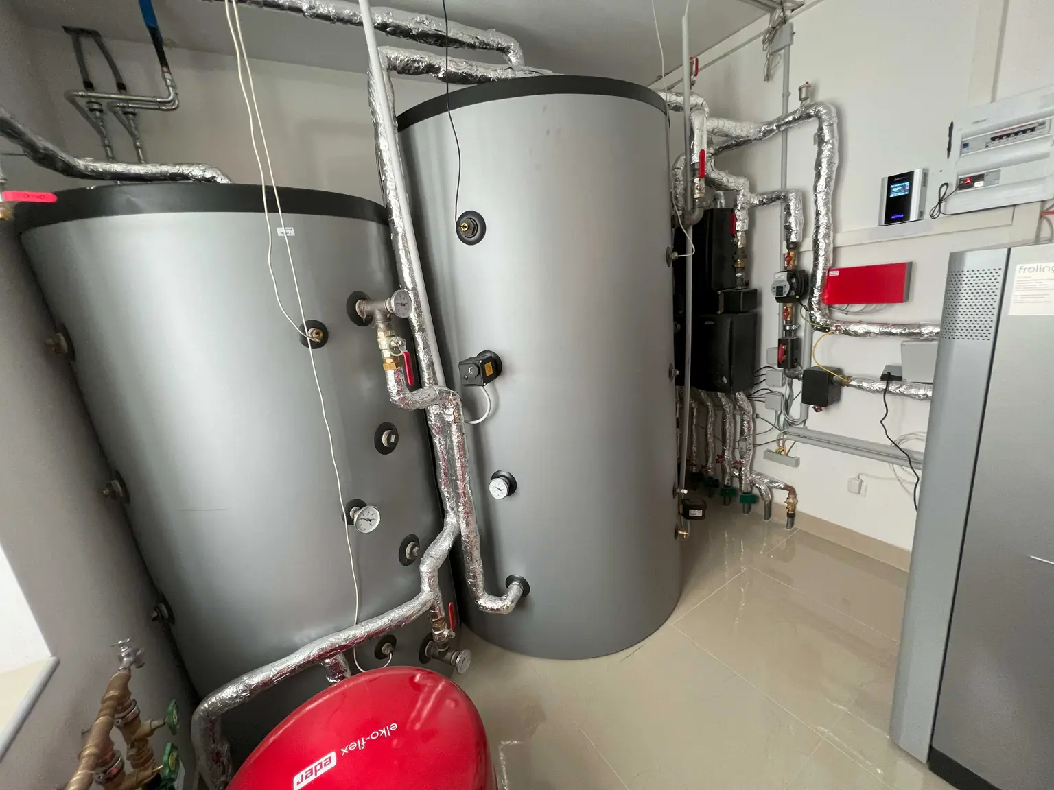 Boiler room with two water heaters and a wall-mounted AC•THOR 9s unit.