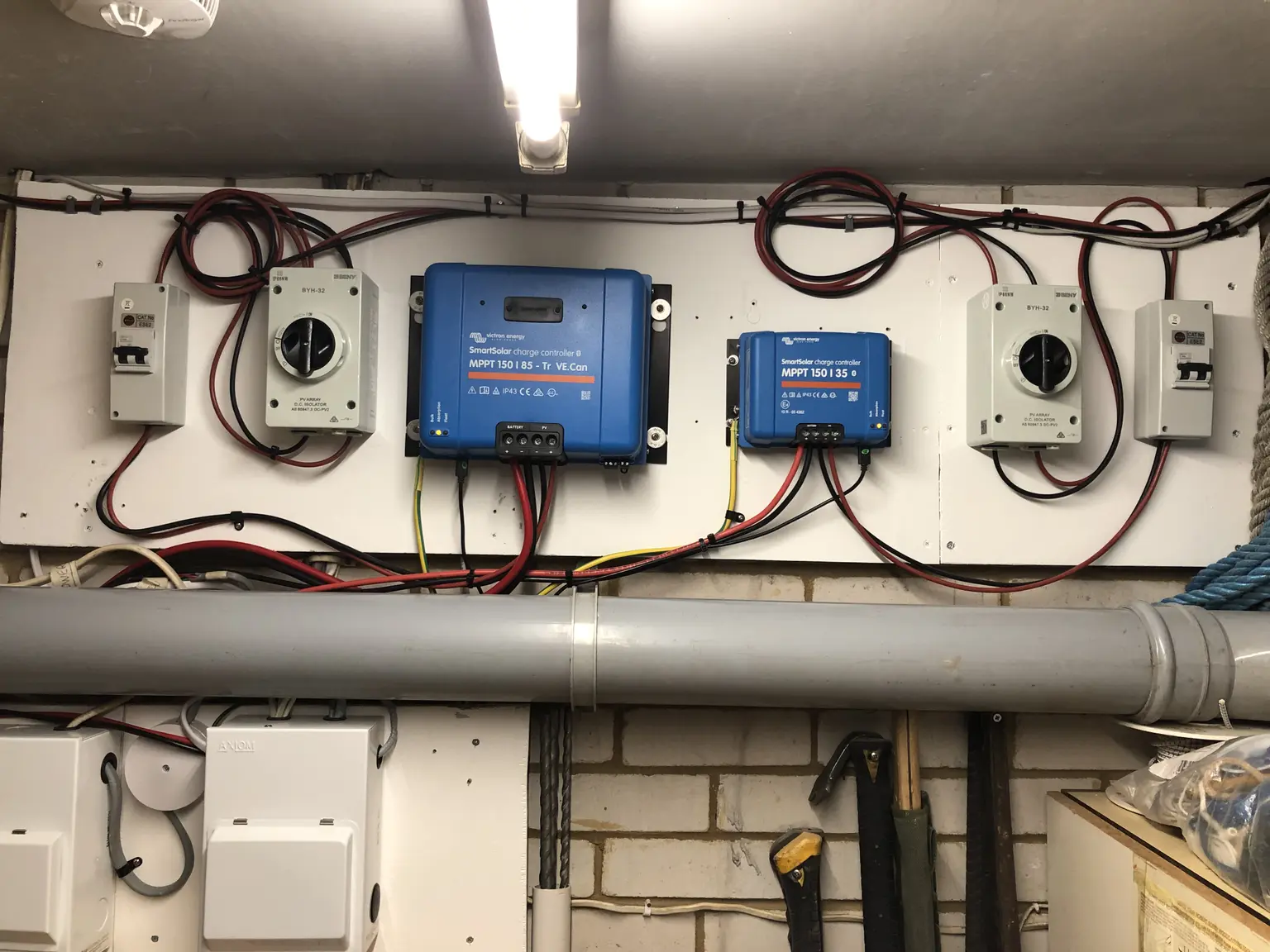 Victron inverter is wall-mounted with multiple cables leading to the main switches of the PV system