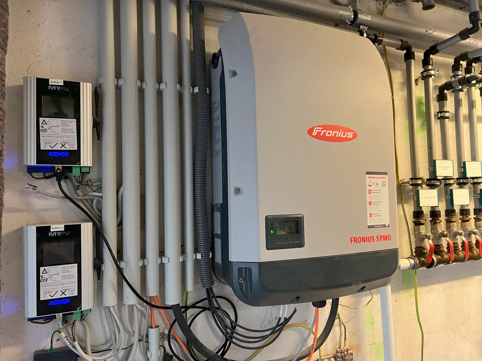 AC•THOR 9s from my-PV connected to Fronius inverter with various cable ducts visible on the wall.