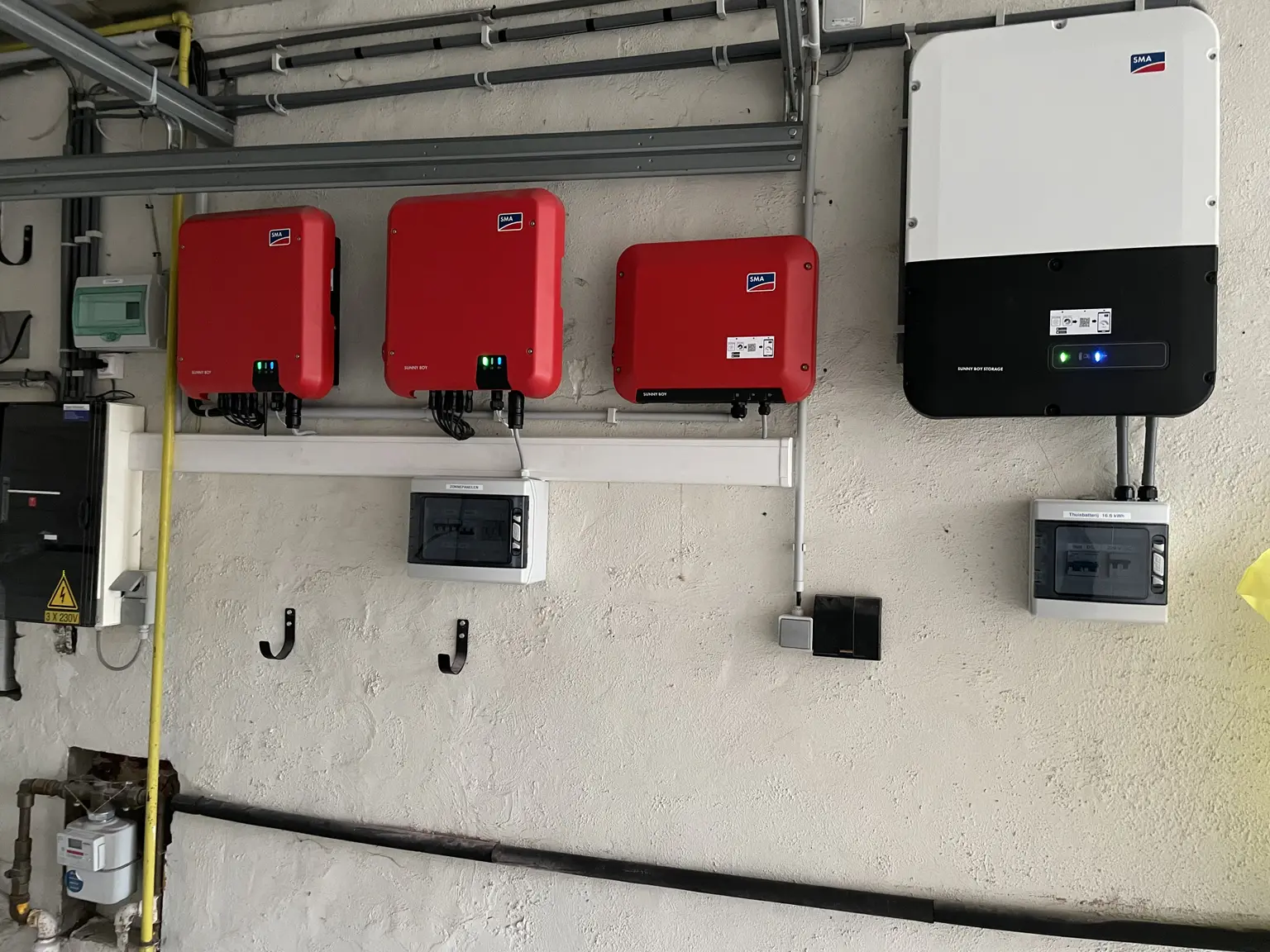 Mounted SMA inverters with green and blue lights indicating they are connected and operating