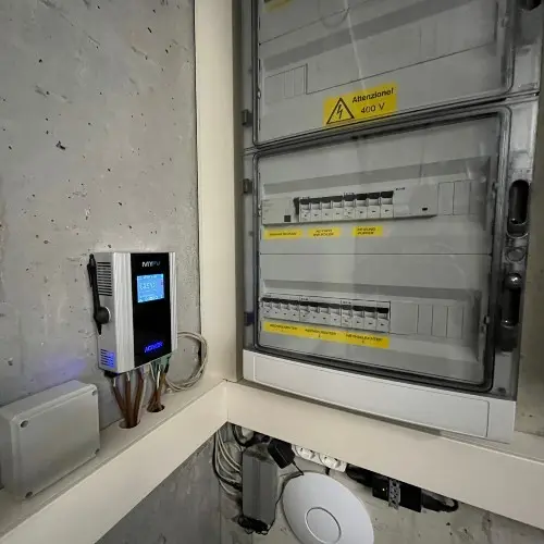 Wall-mounted AC•THOR 9s with electrical switch cabinet beside it.
