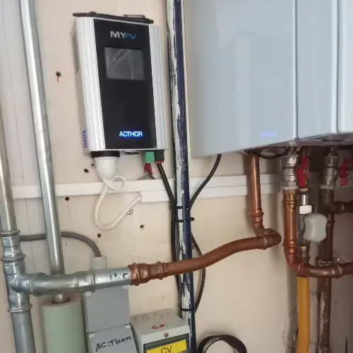 Mounted AC•THOR with cables running into a cable duct, surrounded by various pipes.