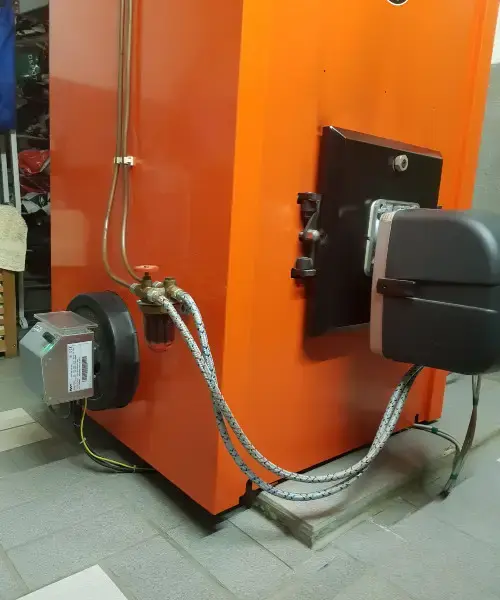 ELWA attached to an orange industrial machine with visible wires and a valve on the right