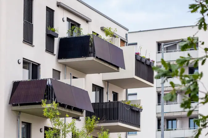 A modern residential complex equipped with balcony solar power systems providing sustainable energy.