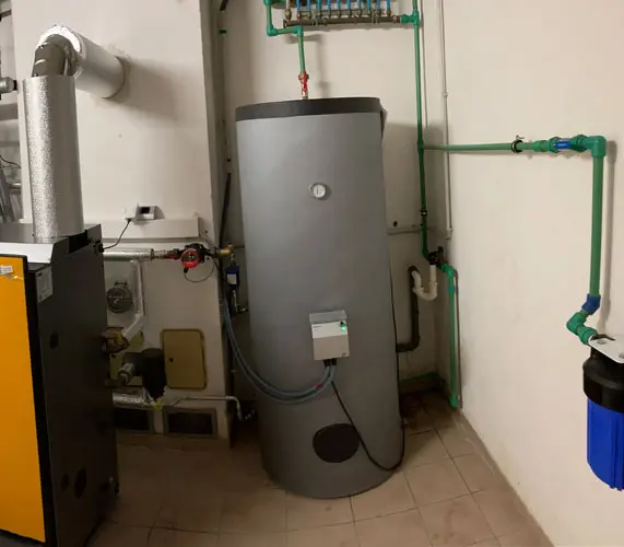 Gray water heater with connected ELWA, green pipes, black filter, and yellow heating unit, in a utility room
