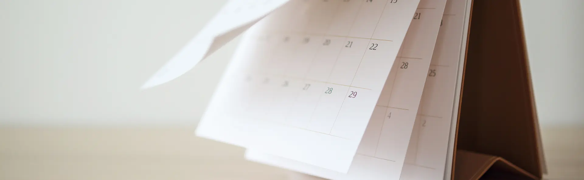Desk calendar with pages gently fluttering upwards.