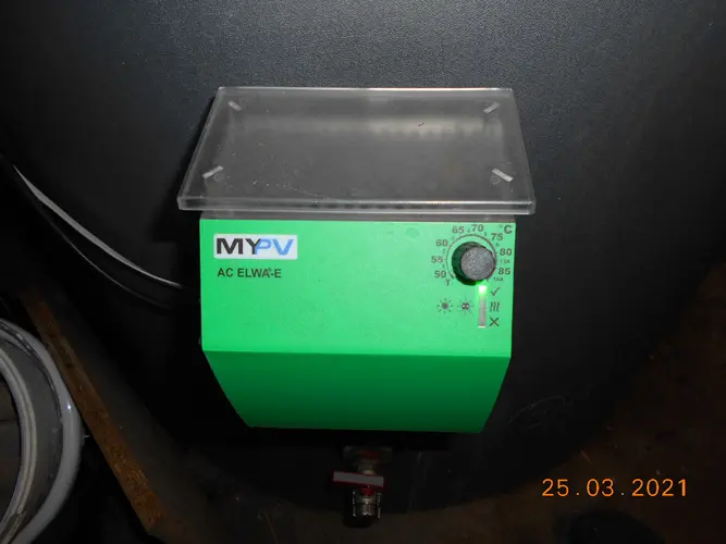 Green my-PV AC ELWA-E device with temperature dial, mounted on a water boiler.