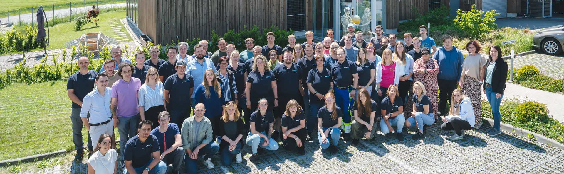 my-PV team in front of the company building