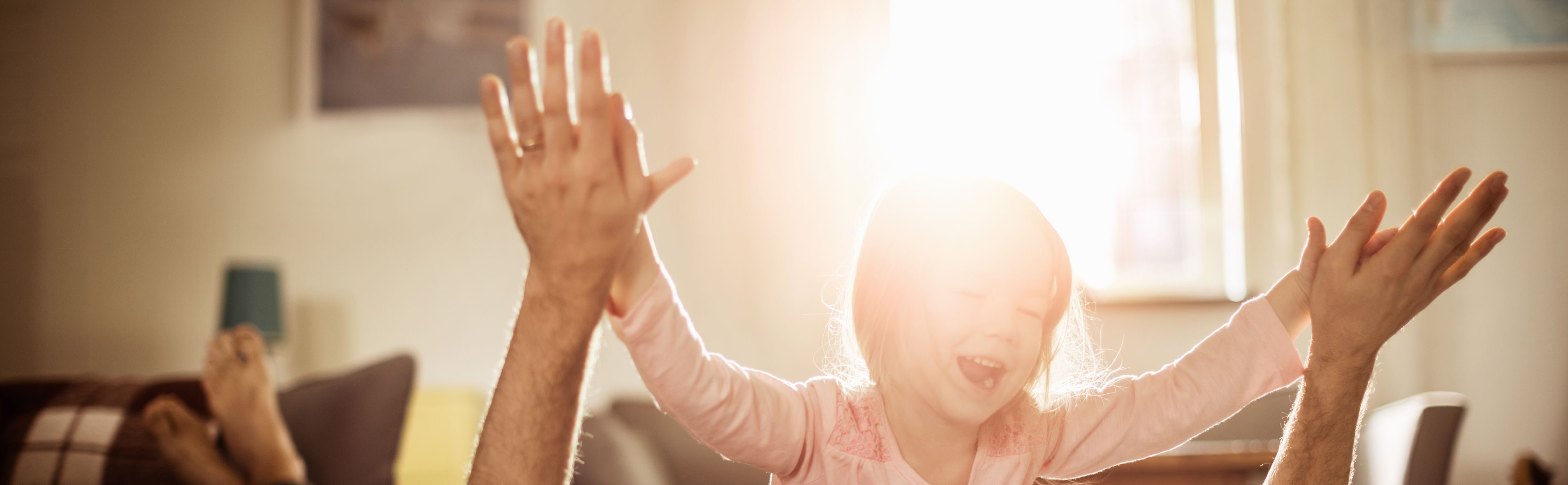 A playing child feels comfortable from the warmth of the heating powered by photovoltaic energy.