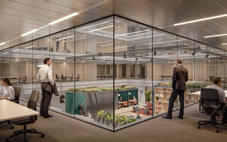 modern office space with glass windows overlooking an atrium