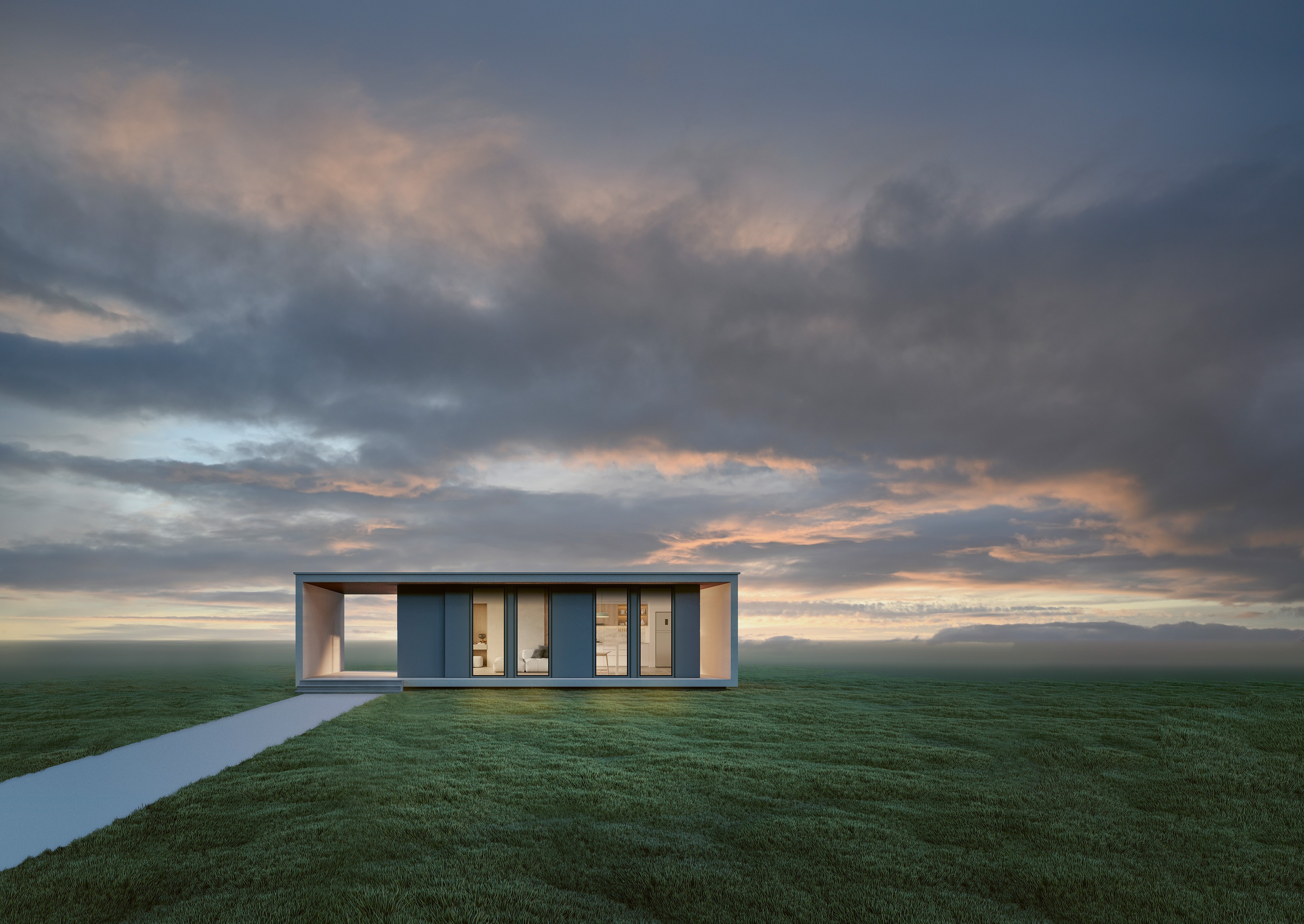 Una casa moderna con grandes ventanas y un techo plano se encuentra en un campo de hierba bajo un cielo nublado.