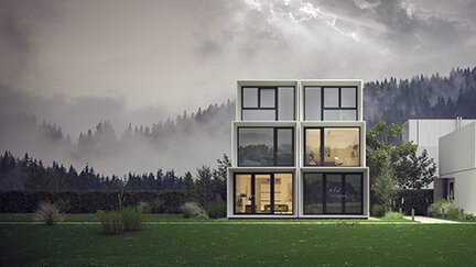 A modern house with glass windows and doors, situated on a grassy field with trees and fog in the background.
