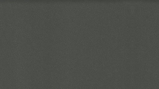 Eine Nahaufnahme eines strukturierten, dunkelgrauen Stoffes mit einem dezenten Muster, möglicherweise für Polster oder Inneneinrichtung verwendet.