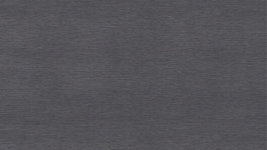 Een close-up van een getextureerde, grijze stof met een subtiel patroon, mogelijk gebruikt voor bekleding of interieurontwerp.