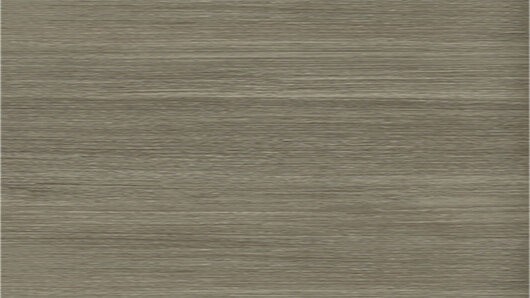 Eine Nahaufnahme einer grauen, strukturierten Oberfläche mit subtilen Farb- und Mustervariationen, die möglicherweise ein Material wie Stoff oder Tapete darstellt.