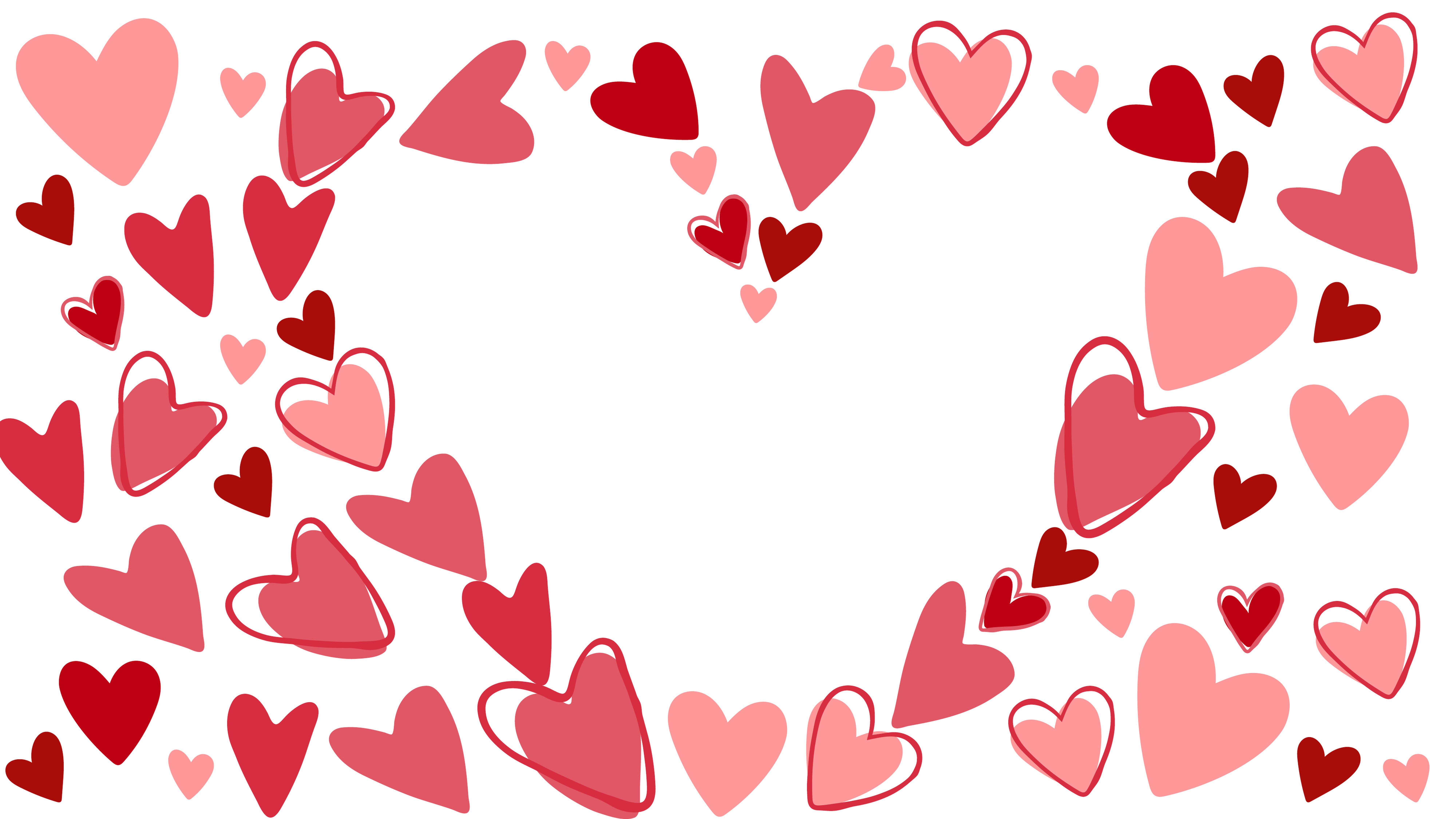 Různé červené a růžové srdce uspořádané v ohraničení, vytvářející tvar srdce uprostřed na bílém pozadí.
