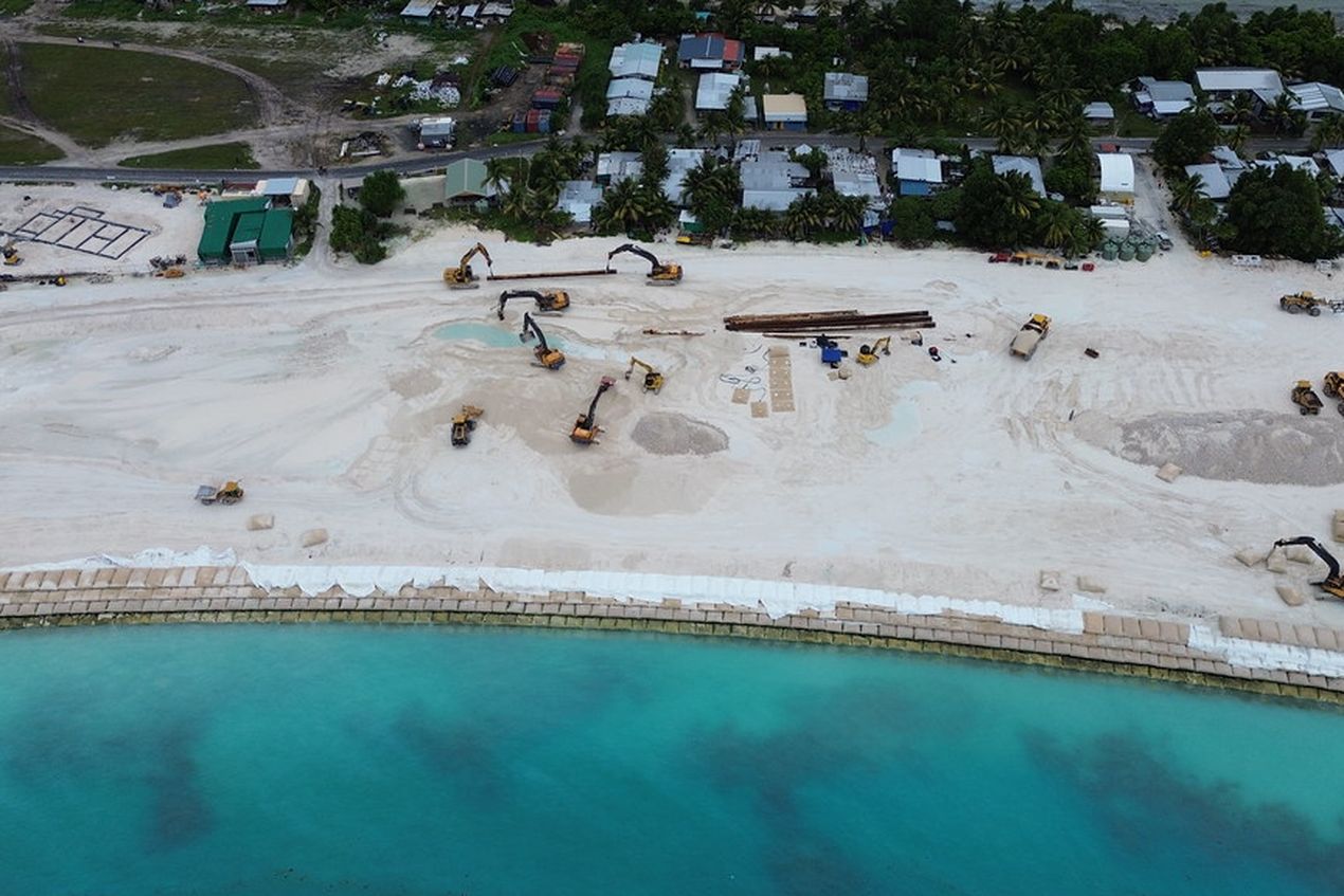 Bulldozers werken op een stuk kustuitbreiding dat Tuvalu moet beschermen tegen de stijgende zeespiegel.