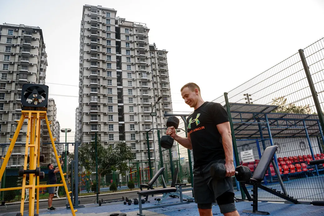Een Russische man traint met gewichten in de buitengym van Green City.