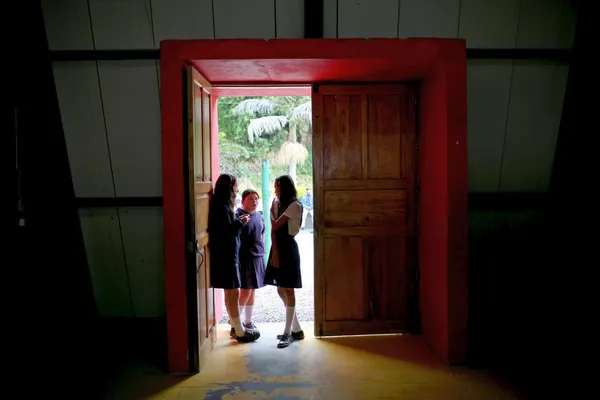 schoolmeisjes staan in de deuropening van een school