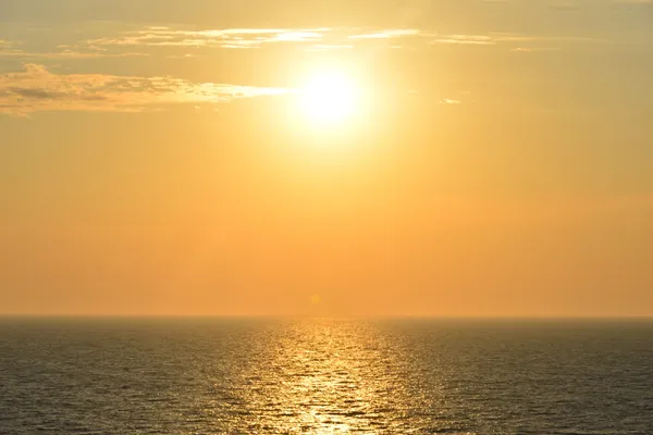 een verzengende zon boven de uitgestrekte zee
