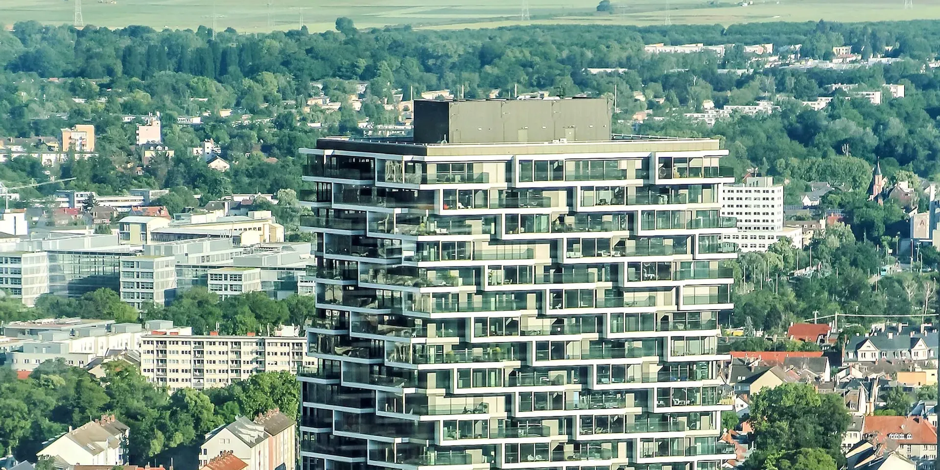 Een appartementsgebouw torent hoog uit boven de omliggende stad