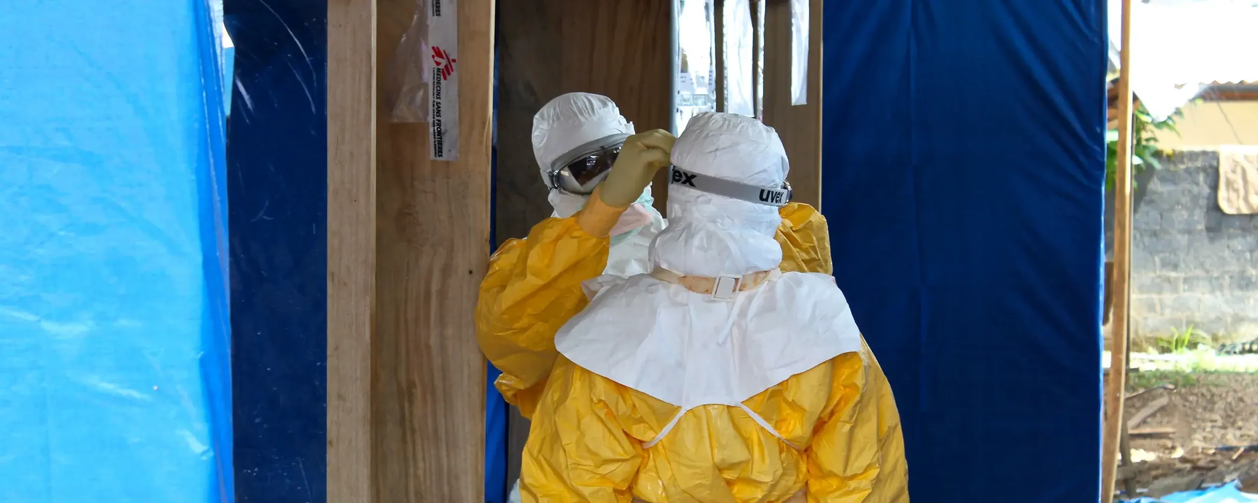 Medisch presoneel kleedt zich in beschermende kledij voor ze ebolapatiënten behandelen