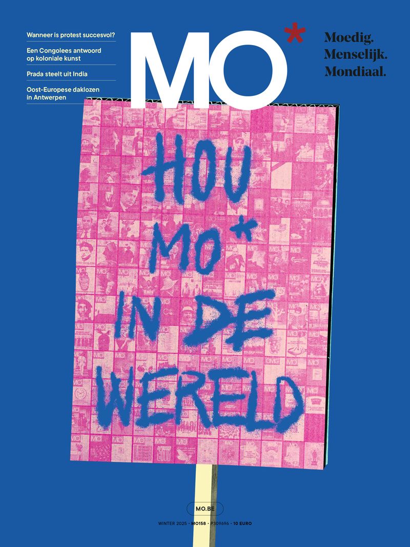 Cover of MO* magazine featuring a blue and pink protest sign with the text "Hou MO* in de wereld" against a blue background.
