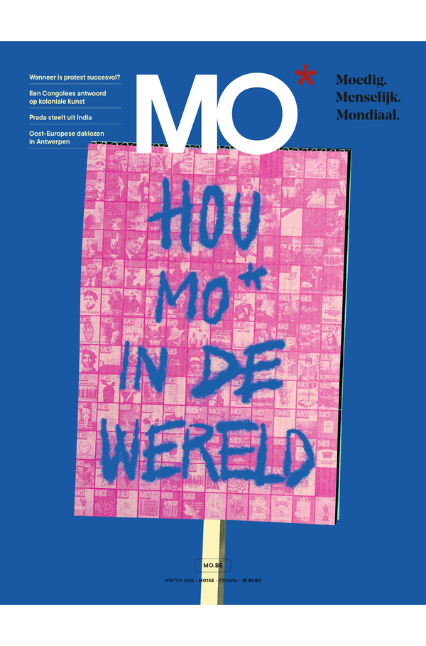 Cover of MO* magazine featuring a blue and pink protest sign with the text "Hou MO* in de wereld" against a blue background.