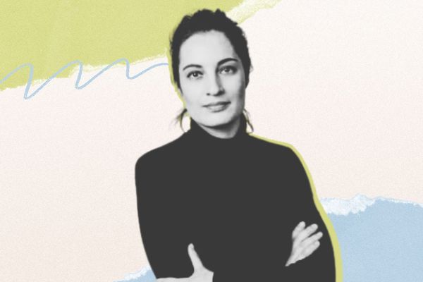 Woman in black turtleneck with arms crossed, set against an abstract pastel background of green, blue, and beige.