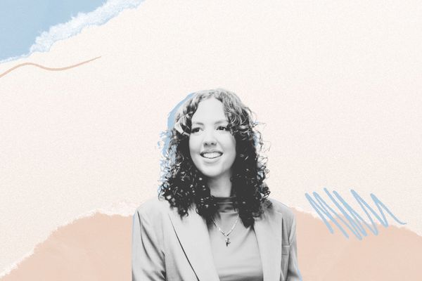 Smiling person with curly hair in a suit, against an abstract pastel-colored background with wavy lines and textured layers.