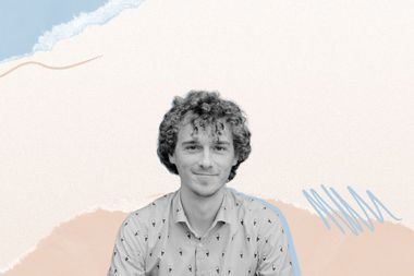 A man with curly hair smiles against an abstract background with wavy blue and beige patterns.